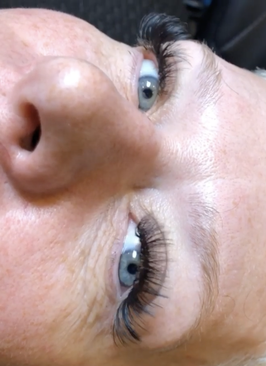This is a photo of a young woman who has just had Hybrid lash extensions added to her own natural lashes. This service was done by Beautify Salon and Spa in Henderson